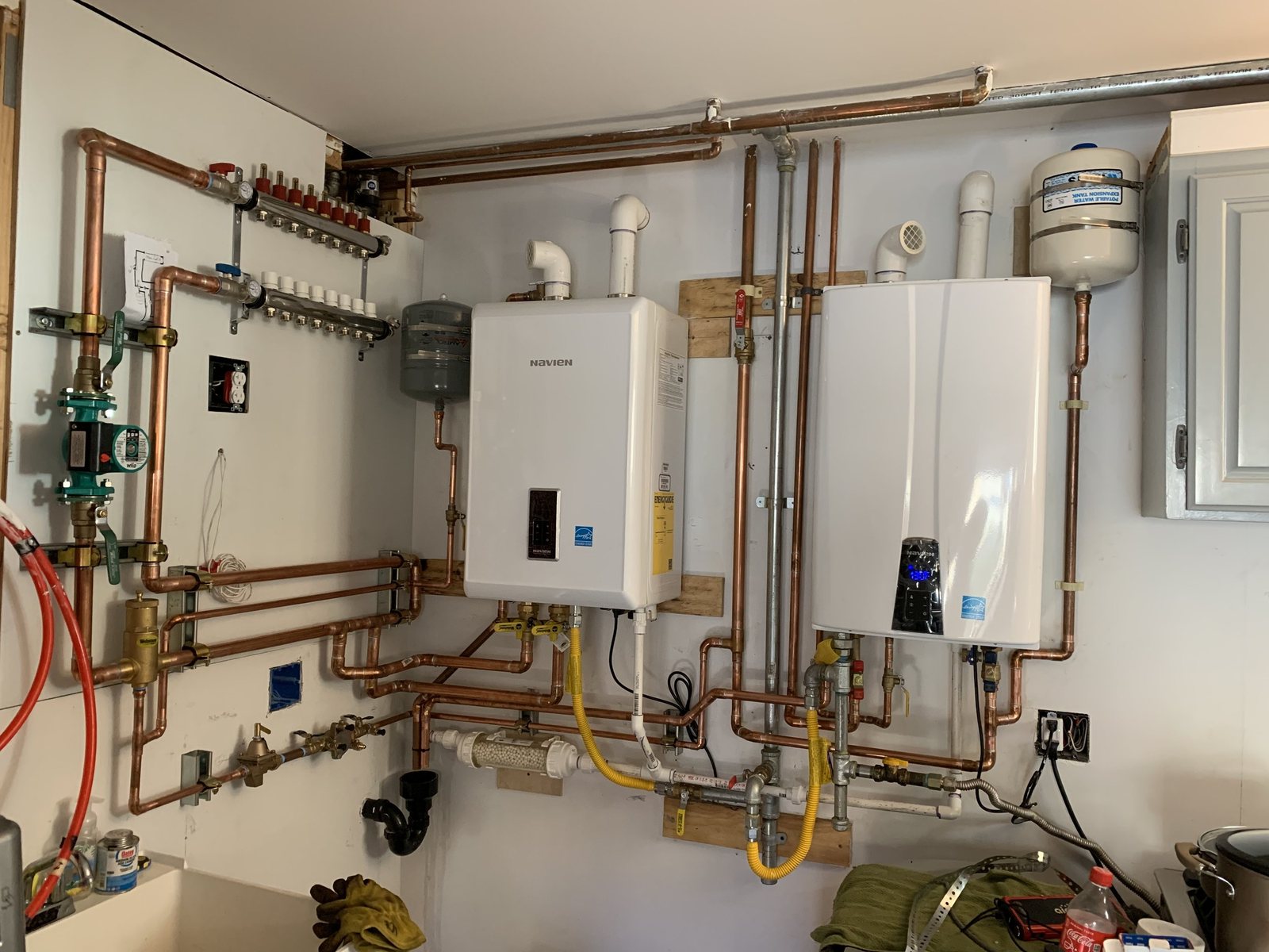 Illustrative photo: tankless water heaters with copper piping